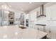 Modern kitchen with white cabinets, quartz countertops, and large island at 27750 E Lakeview Dr, Aurora, CO 80016