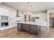 Modern kitchen with white cabinets, quartz countertops, and large island at 27750 E Lakeview Dr, Aurora, CO 80016