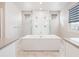 Luxurious bathroom with soaking tub, double shower heads, and modern vanity at 27750 E Lakeview Dr, Aurora, CO 80016