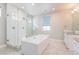 Spa-like bathroom with large soaking tub, walk-in shower, and gray tile flooring at 27750 E Lakeview Dr, Aurora, CO 80016