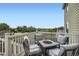 Outdoor deck with a seating area, fire pit, and scenic views at 942 Wagon Bend Rd, Berthoud, CO 80513