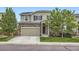 Charming two-story home with stone accents, lush landscaping, and a two-car garage at 942 Wagon Bend Rd, Berthoud, CO 80513
