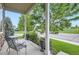 Inviting front porch with comfortable seating and views of the well-maintained lawn at 942 Wagon Bend Rd, Berthoud, CO 80513