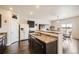 Well-equipped kitchen with dark wood cabinets, laminate countertops, and stainless steel sink at 942 Wagon Bend Rd, Berthoud, CO 80513