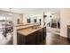 Open-concept kitchen with dark cabinetry, granite countertops, and modern appliances at 942 Wagon Bend Rd, Berthoud, CO 80513