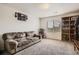Spacious living room with a plush sofa, large window, and built-in shelving at 942 Wagon Bend Rd, Berthoud, CO 80513