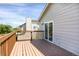 Wooden back deck off of the main floor with sliding glass door and house siding at 12089 W Burgundy Ave, Littleton, CO 80127