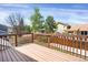 Back deck with wooden railing overlooking the backyard at 12089 W Burgundy Ave, Littleton, CO 80127