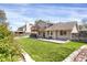 Landscaped backyard with grass, and back deck on house at 12089 W Burgundy Ave, Littleton, CO 80127