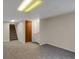 Finished basement with storage and carpet; accessible by stairs with adjacent doors for added convenience at 12089 W Burgundy Ave, Littleton, CO 80127