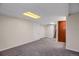 Finished basement with neutral carpet offering versatile space for recreation or storage at 12089 W Burgundy Ave, Littleton, CO 80127