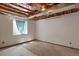 Unfinished basement with concrete floor, exposed ceiling, and a window letting in natural light at 12089 W Burgundy Ave, Littleton, CO 80127