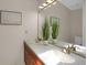 Well-lit bathroom with double sinks, framed mirror, and decorative plants adding a fresh touch at 12089 W Burgundy Ave, Littleton, CO 80127