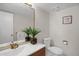 Charming bathroom with unique mirror, modern sink and vanity, toilet, and themed wall decor at 12089 W Burgundy Ave, Littleton, CO 80127