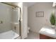 Bright bathroom featuring tile flooring, double sinks, and a glass enclosed shower and bathtub at 12089 W Burgundy Ave, Littleton, CO 80127