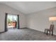 Spacious bedroom featuring carpeted floors and sliding glass doors to outdoor deck at 12089 W Burgundy Ave, Littleton, CO 80127