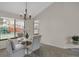 Bright dining area with a modern chandelier and a view of the outdoors at 12089 W Burgundy Ave, Littleton, CO 80127