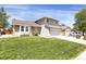 Lovely two-story home featuring a lush green lawn and an attached two-car garage at 12089 W Burgundy Ave, Littleton, CO 80127
