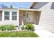 Attractive home entrance with well-kept lawn, showcasing the brick facade and inviting front door at 12089 W Burgundy Ave, Littleton, CO 80127