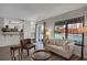 Bright living room with hardwood floors, large window, and view into the kitchen at 12089 W Burgundy Ave, Littleton, CO 80127
