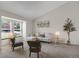 Cozy living room with neutral decor, carpet, and a decorative tree next to the side table at 12089 W Burgundy Ave, Littleton, CO 80127