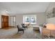 Bright living room featuring neutral paint, carpet, and furniture with natural light from the bay window at 12089 W Burgundy Ave, Littleton, CO 80127