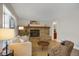 Inviting living room showcasing a brick fireplace, hardwood floors, and modern neutral decor at 12089 W Burgundy Ave, Littleton, CO 80127