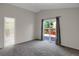 Spacious main bedroom features neutral carpet, vaulted ceiling, and sliding glass doors to a private deck at 12089 W Burgundy Ave, Littleton, CO 80127