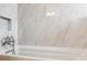 White marble tile surround in tub/shower, with a mosaic tiled inset niche at 5856 Simms St, Arvada, CO 80004