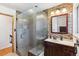 Updated bathroom with glass shower and attractive stone tile accents at 5856 Simms St, Arvada, CO 80004