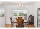 Bright dining room with a chandelier and wood table and chairs next to the living room at 5856 Simms St, Arvada, CO 80004