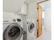 Laundry room with new washer and dryer, plus storage and easy access to the bath at 5856 Simms St, Arvada, CO 80004