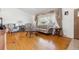 Cozy living room featuring hardwood floors, a large window with decorative drapes, and comfortable seating at 5856 Simms St, Arvada, CO 80004