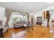 Well-lit living room features hardwood floors, coat rack, staircase, and a large front window at 5856 Simms St, Arvada, CO 80004