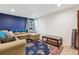 Cozy living room with blue accent wall, comfortable seating, and decorative rug at 5856 Simms St, Arvada, CO 80004