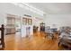 Bright living room with hardwood floors, large windows, and open access to the dining room and kitchen at 5856 Simms St, Arvada, CO 80004