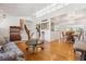 Open living space with hardwood floors connecting living, dining, and kitchen areas with bright natural light at 5856 Simms St, Arvada, CO 80004