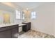 Modern bathroom featuring double vanities, dark cabinets, and modern tile flooring at 24715 E Evans Dr, Aurora, CO 80018