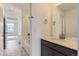 Bright bathroom featuring a white vanity with a gray countertop and a shower-over-tub with white subway tile at 24715 E Evans Dr, Aurora, CO 80018