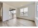 Bright dining area with sliding glass door to the patio and light colored wood flooring at 24715 E Evans Dr, Aurora, CO 80018