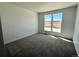 A carpeted bedroom filled with natural light from its double windows at 25343 E Warren Pl, Aurora, CO 80018