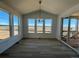 Bright dining area with hardwood floors, stylish lighting, and access to a patio at 25343 E Warren Pl, Aurora, CO 80018