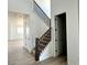 Bright entryway featuring wood-look floors and a staircase with dark wood railing at 25343 E Warren Pl, Aurora, CO 80018
