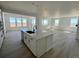 Bright and airy kitchen with a spacious island, modern faucet, and open access to other rooms at 25343 E Warren Pl, Aurora, CO 80018