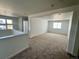 Cozy loft space with neutral carpet and ample natural light from large windows at 25343 E Warren Pl, Aurora, CO 80018
