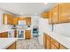 Kitchen with oak cabinets, white countertops, and appliances at 793 S 22Nd Ave, Brighton, CO 80601