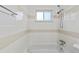 Bathroom with a bathtub and shower, and neutral tile at 9868 Appletree Pl, Thornton, CO 80260