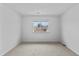 Spacious bedroom with neutral carpeting and a window at 9868 Appletree Pl, Thornton, CO 80260