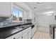 White kitchen cabinets, stainless steel appliances, and a tile backsplash at 9868 Appletree Pl, Thornton, CO 80260