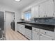 Modern kitchen with white cabinets, stainless steel appliances, and tile flooring at 9868 Appletree Pl, Thornton, CO 80260